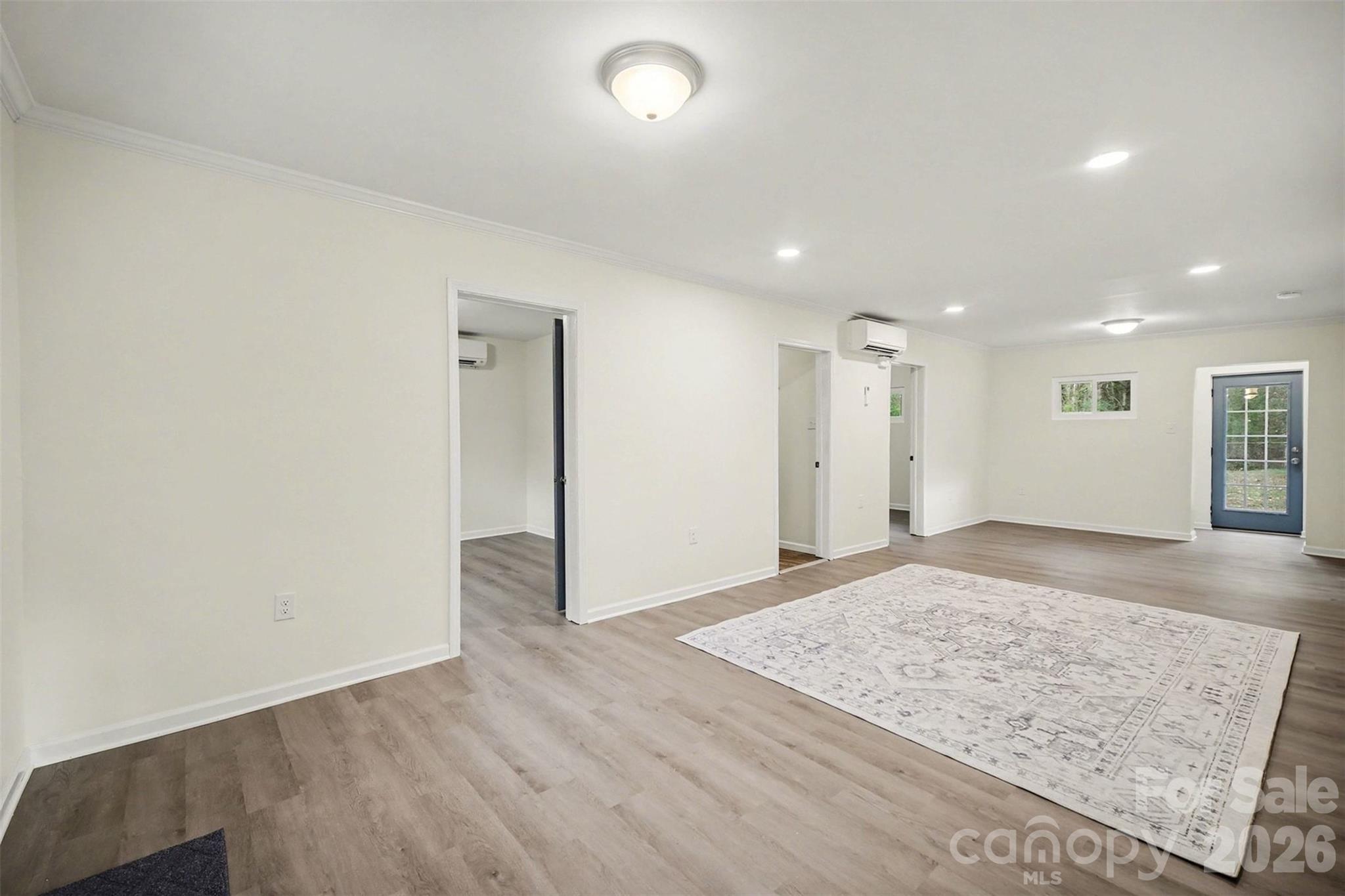 112 Lineberger Street Stanley, NC 28164 - Photo 28 of 32 an empty room with wooden floor and window