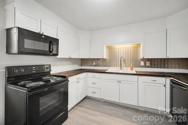 a kitchen with cabinets stainless steel appliances and a sink