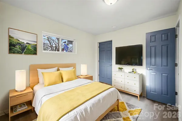 a bedroom with a bed and a flat screen tv