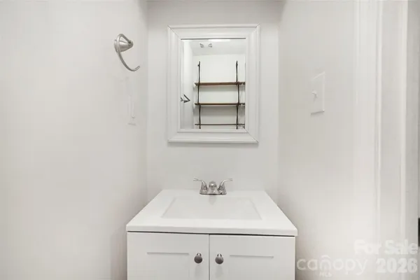 a bathroom with a sink vanity and a window