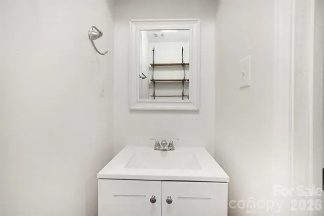 a bathroom with a sink vanity and a window