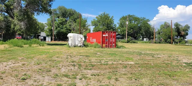 a view of a field with trees