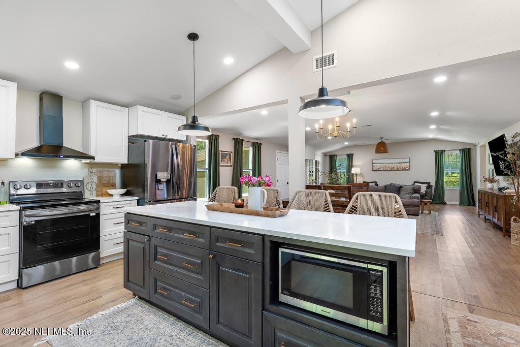 86290 Weldon Road Yulee, FL 32097 - Photo 13 of 50 a kitchen with a stove and a chandelier