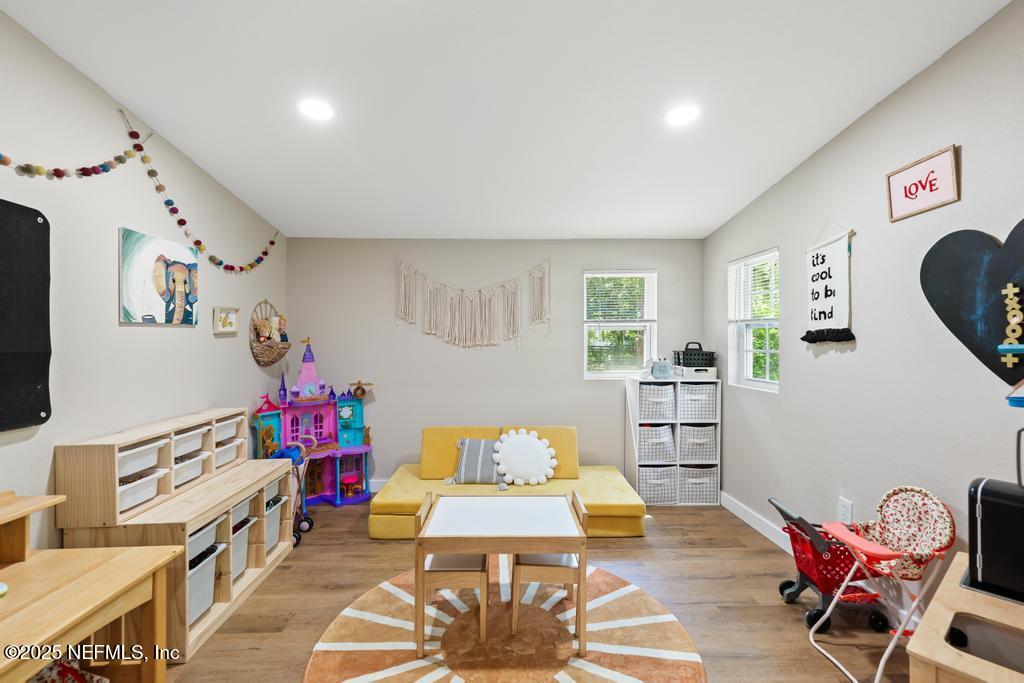 86290 Weldon Road Yulee, FL 32097 - Photo 17 of 50 a bedroom with furniture and a flat screen tv