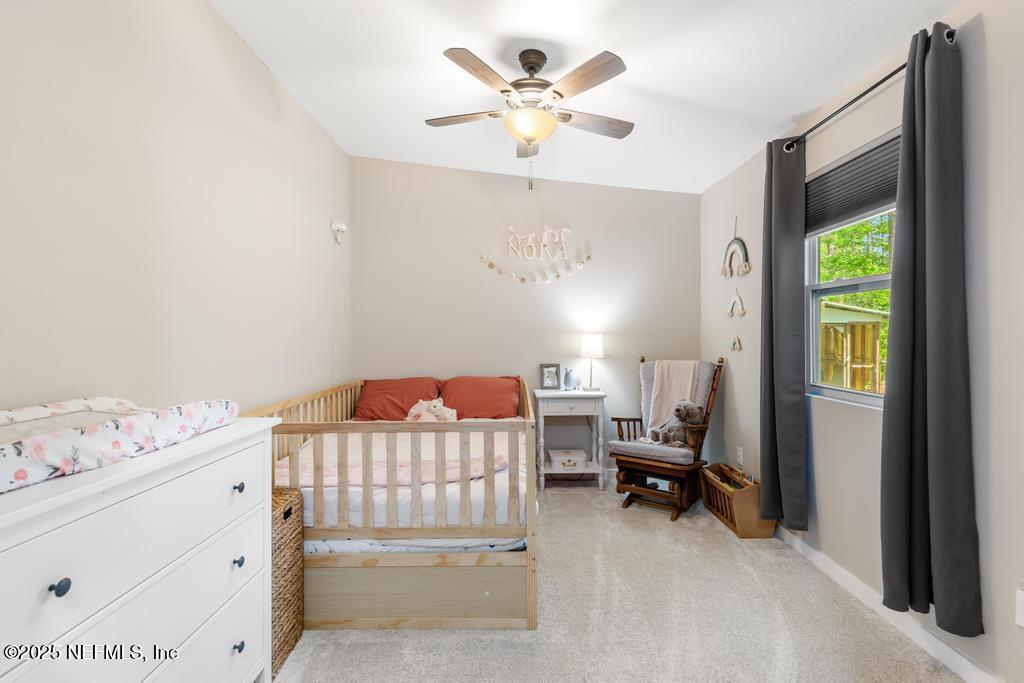 86290 Weldon Road Yulee, FL 32097 - Photo 21 of 50 a bedroom with a bed and a window