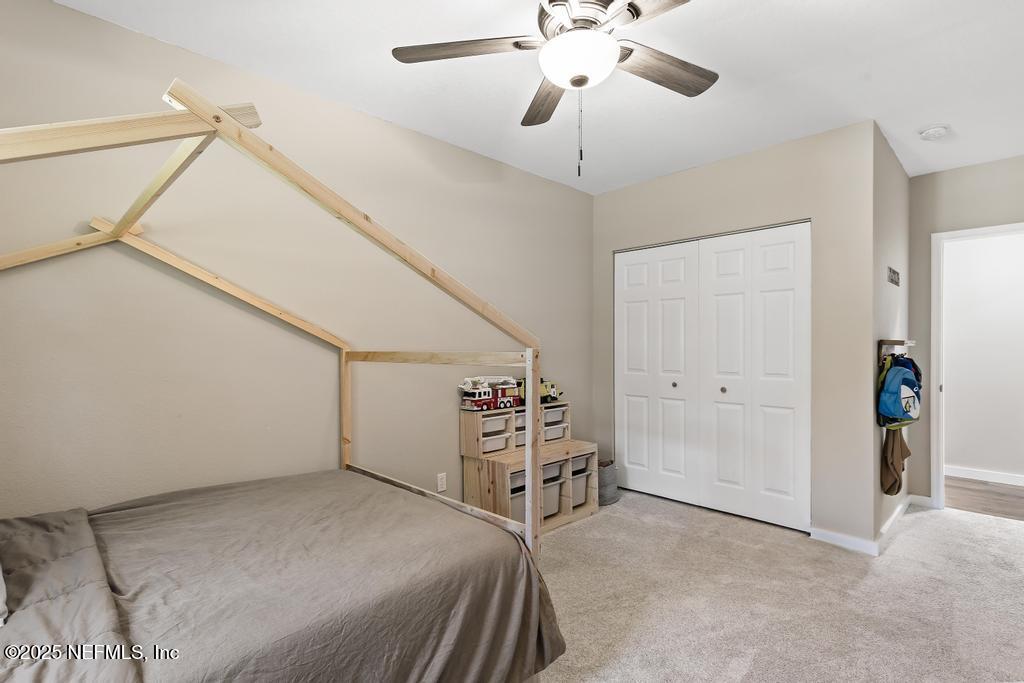 86290 Weldon Road Yulee, FL 32097 - Photo 26 of 50 a view of a livingroom with furniture and a ceiling fan
