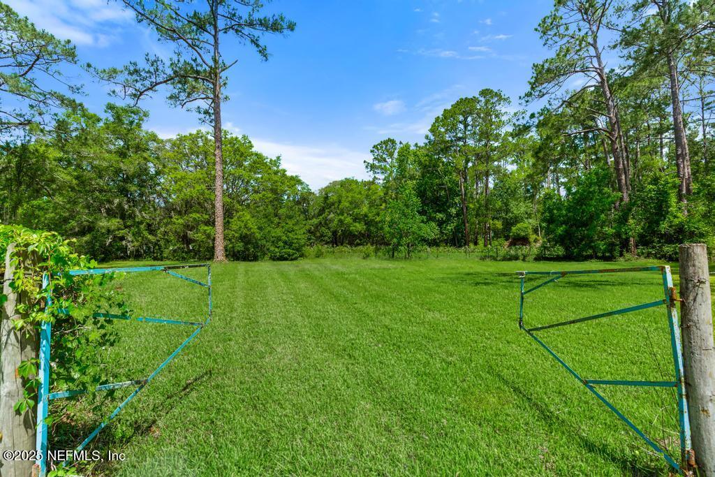 86290 Weldon Road Yulee, FL 32097 - Photo 33 of 50 a view of a white house with a yard