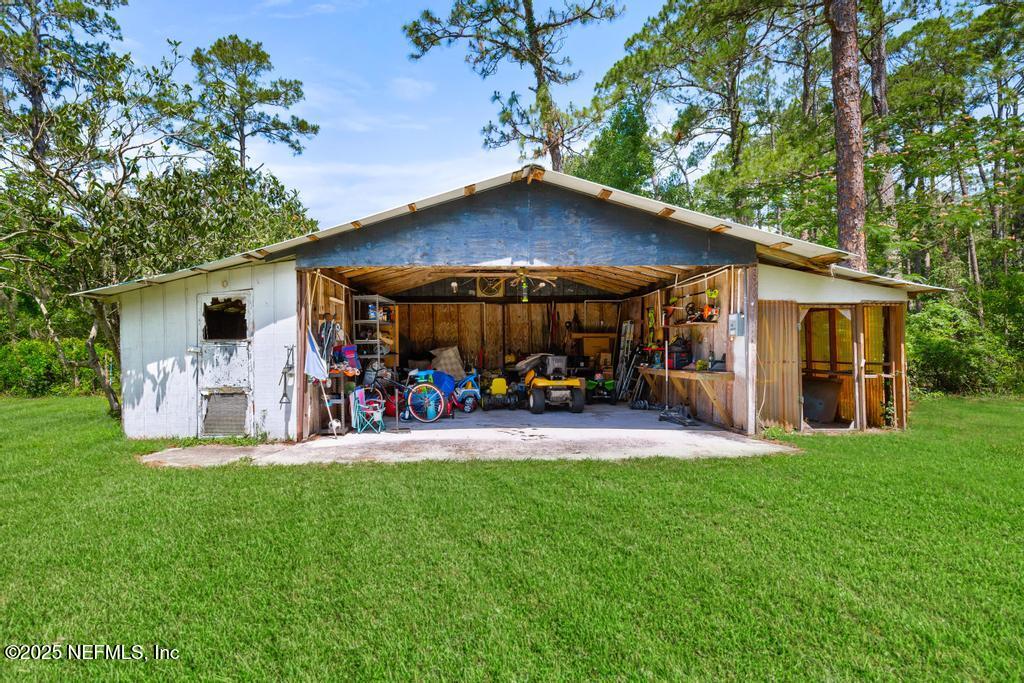 86290 Weldon Road Yulee, FL 32097 - Photo 38 of 50 a view of a chairs and a table in the back yard of the house