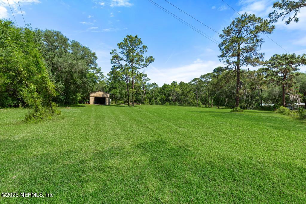 86290 Weldon Road Yulee, FL 32097 - Photo 40 of 50 a view of a green field with wooden fence