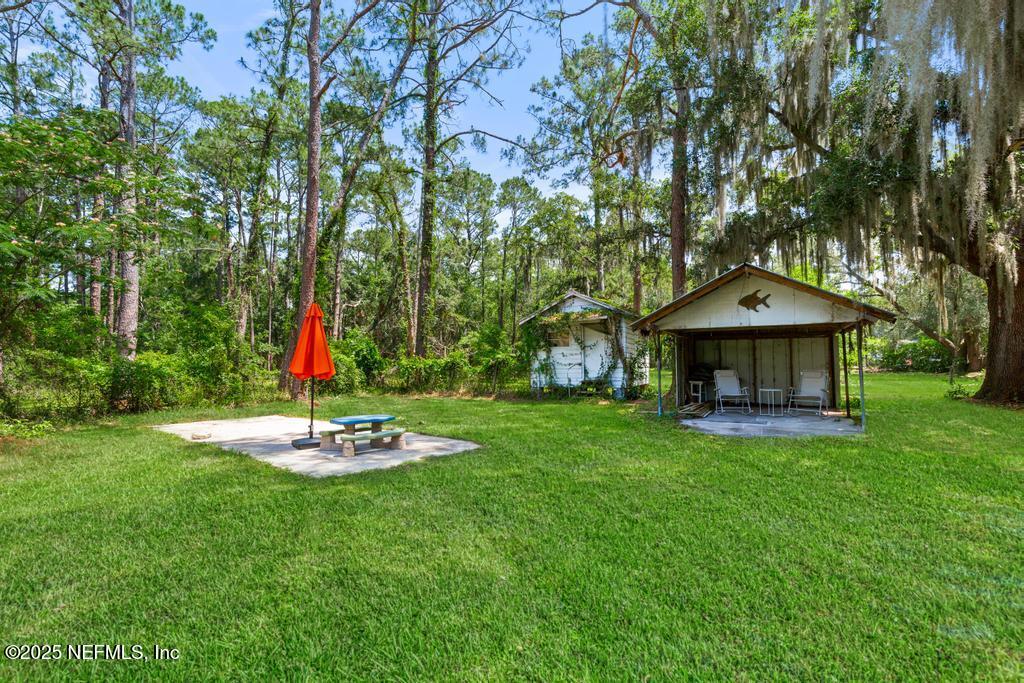 86290 Weldon Road Yulee, FL 32097 - Photo 41 of 50 a front view of a house with a yard table and chairs