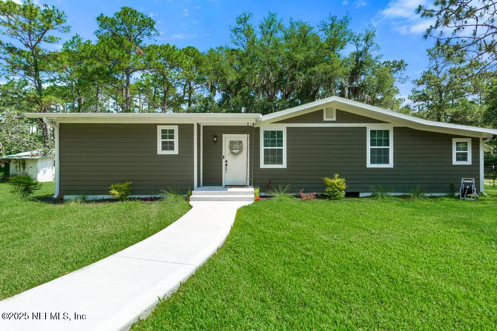 86290 Weldon Road Yulee, FL 32097 - Photo 49 of 50 a front view of a house with a garden