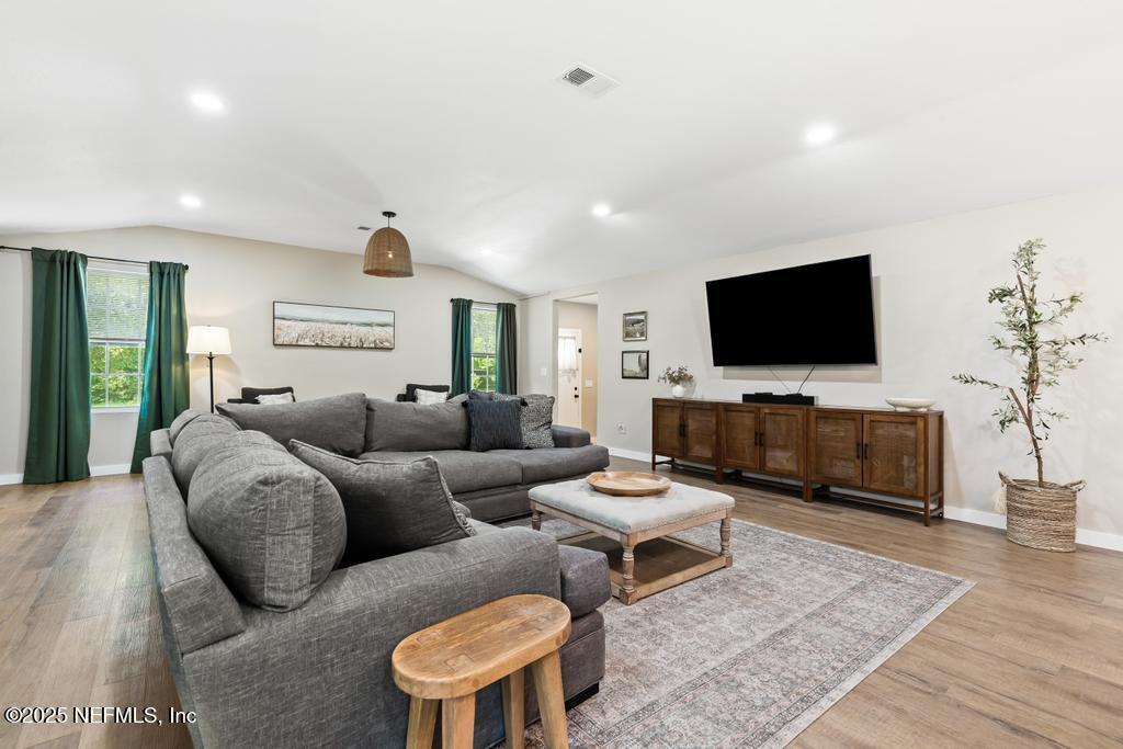 86290 Weldon Road Yulee, FL 32097 - Photo 8 of 50 a living room with furniture and a flat screen tv