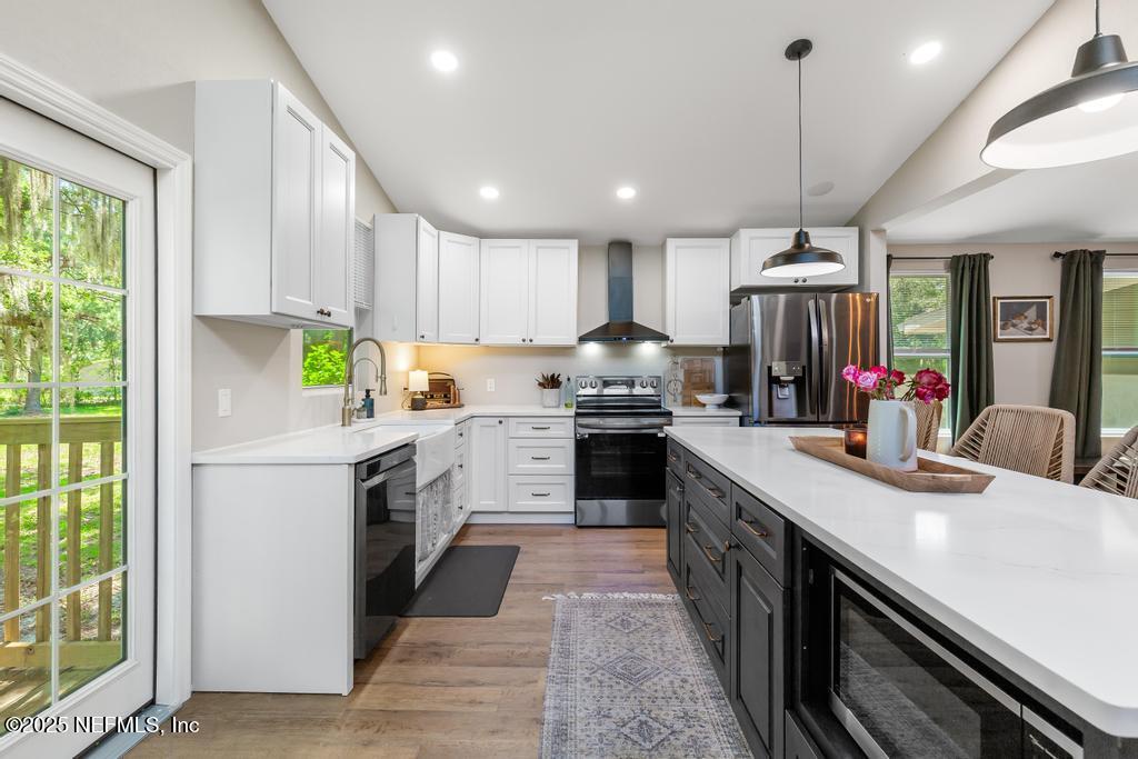 86290 Weldon Road Yulee, FL 32097 - Photo 10 of 50 a kitchen with a sink stove and cabinets