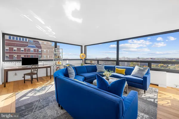 a living room with furniture and a floor to ceiling window