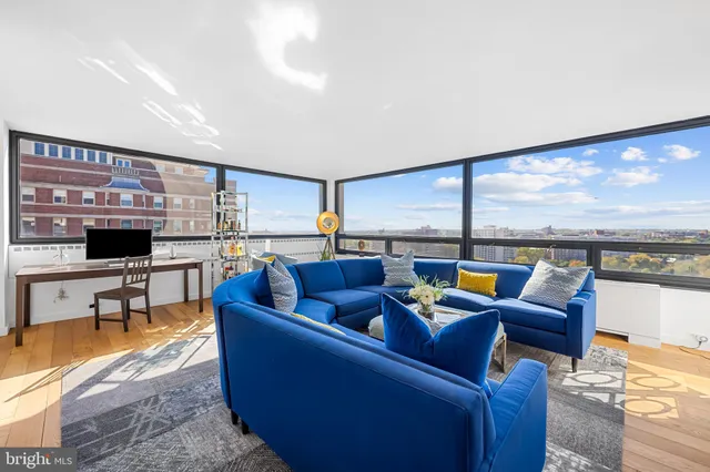 a living room with furniture and a floor to ceiling window