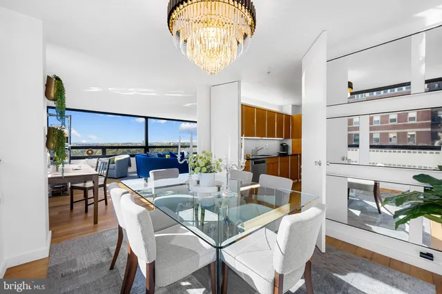 a view of a dining room with furniture and chandelier