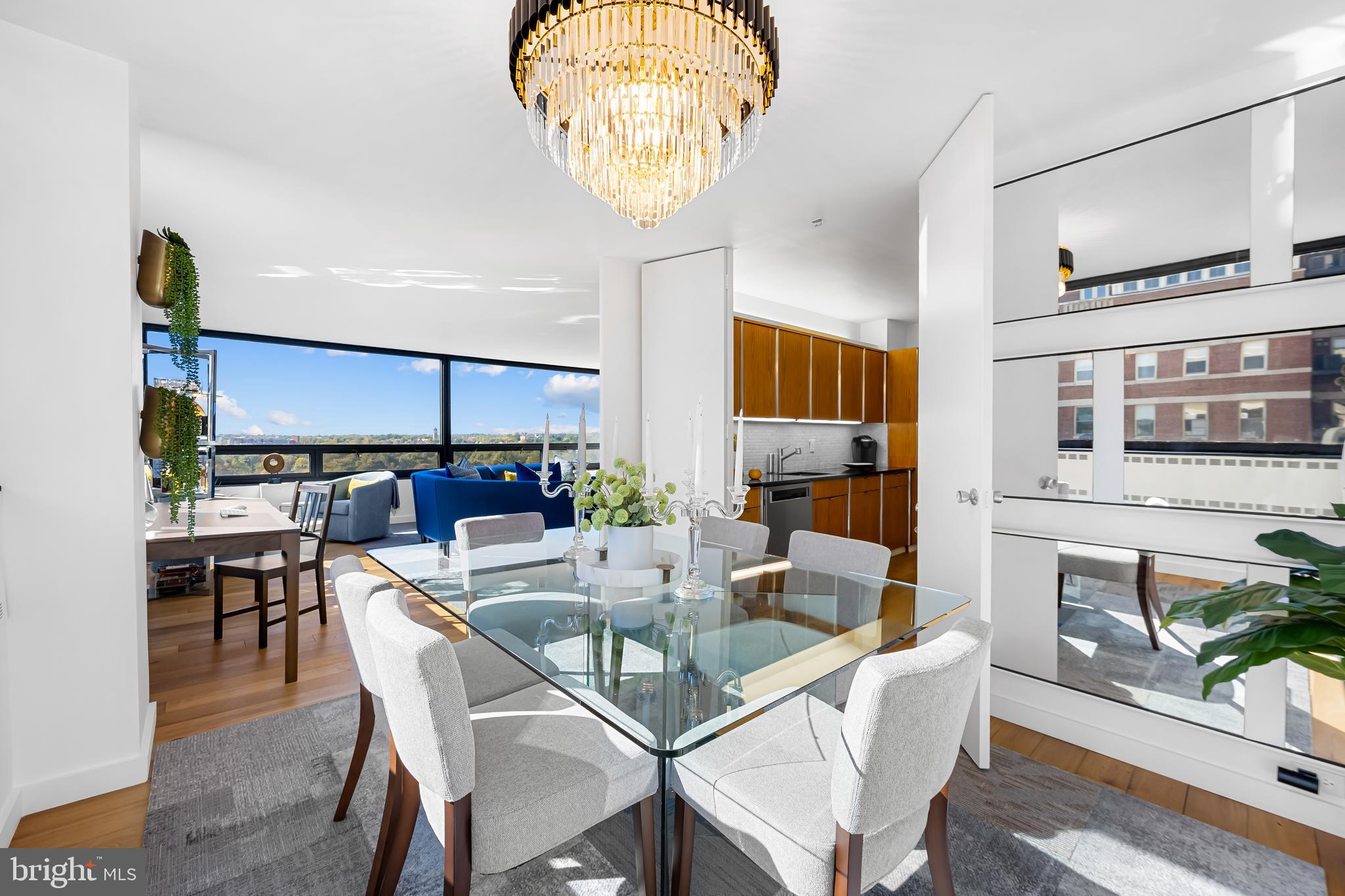 4000 North Charles Street, Unit 1414 Baltimore, MD 21218 - Photo 13 of 45 a dining room with furniture a chandelier and wooden floor
