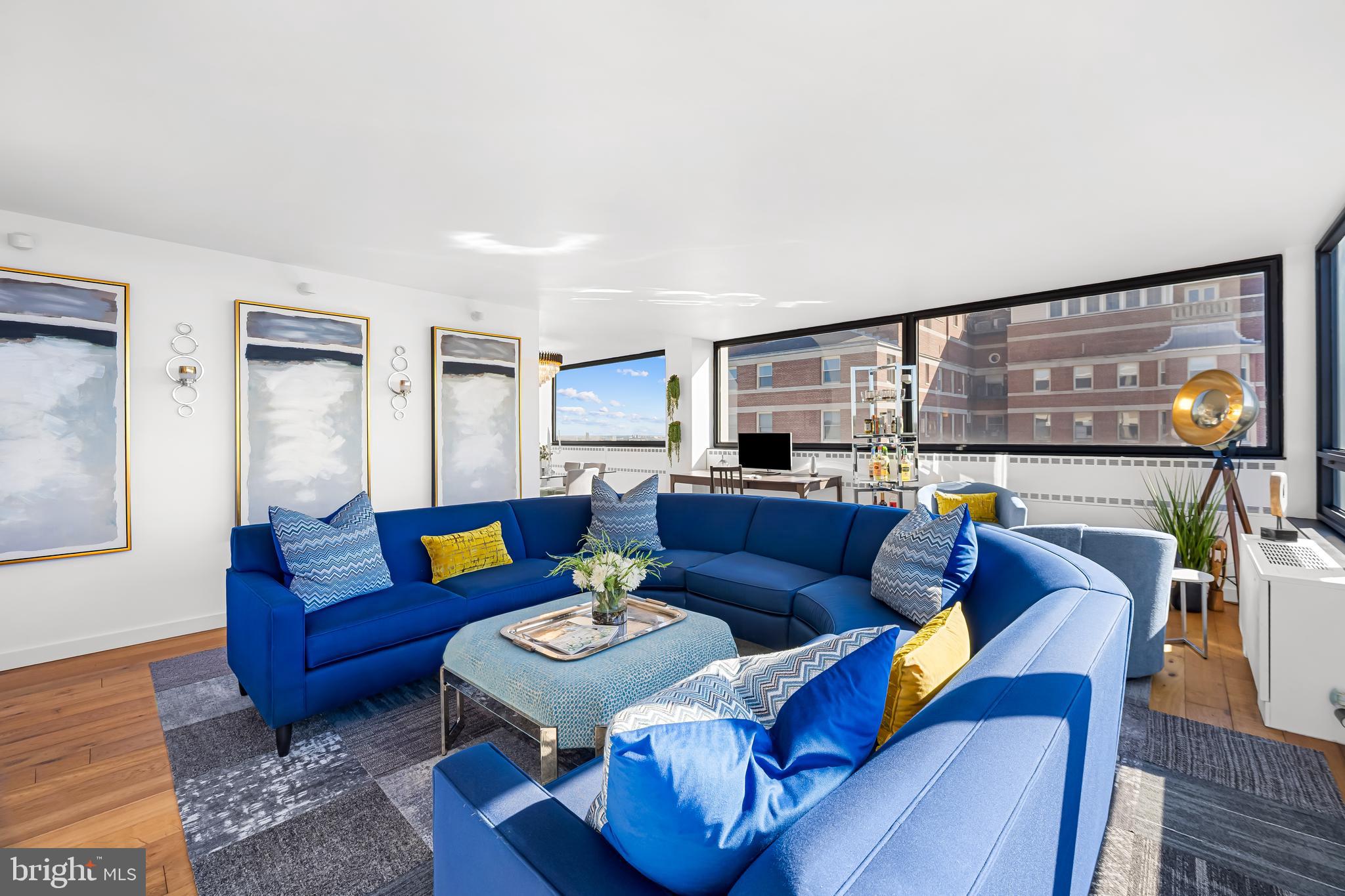 4000 North Charles Street, Unit 1414 Baltimore, MD 21218 - Photo 17 of 45 a living room with furniture and a floor to ceiling window