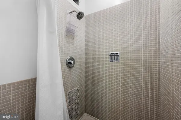 a living room with furniture and floor to ceiling windows