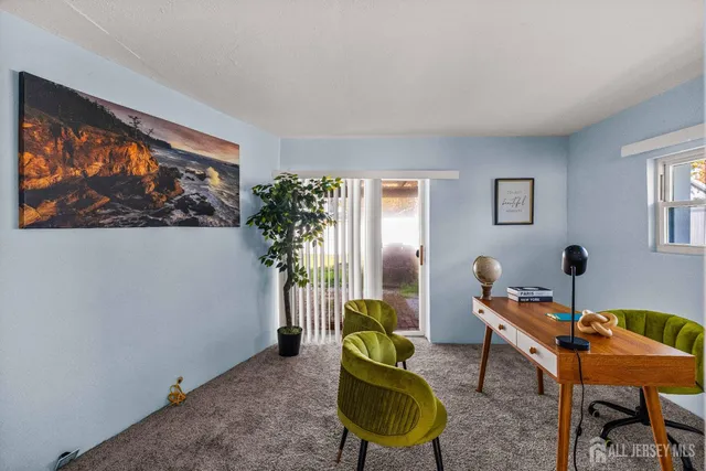a living room with furniture a window and a flat screen tv