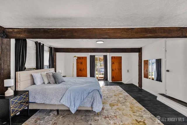 a spacious bedroom with a bed and window