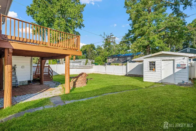 a view of a house with a yard and a patio