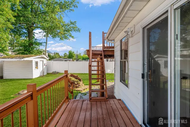 a view of a wooden deck and a backyard