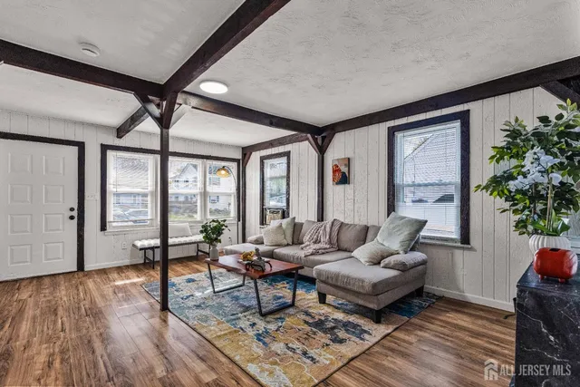 a living room with furniture and a large window with wooden floor