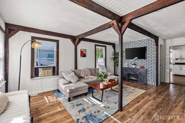 a living room with furniture fireplace and flat screen tv