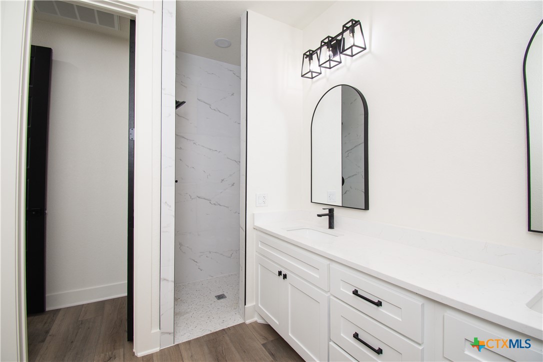 4245 Stringtown Road Temple, TX 76501 - Photo 13 of 25 a bathroom with a sink and a mirror