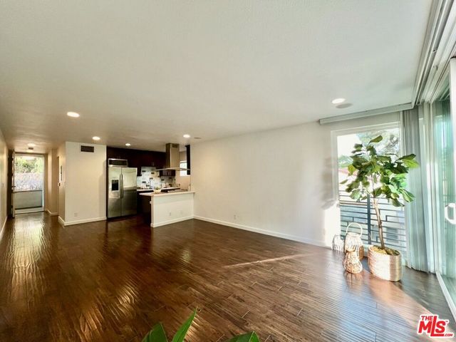 a view of kitchen with livingroom and wooden floor