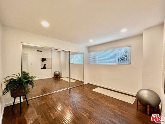a view of a livingroom with wooden floor and a cabinet