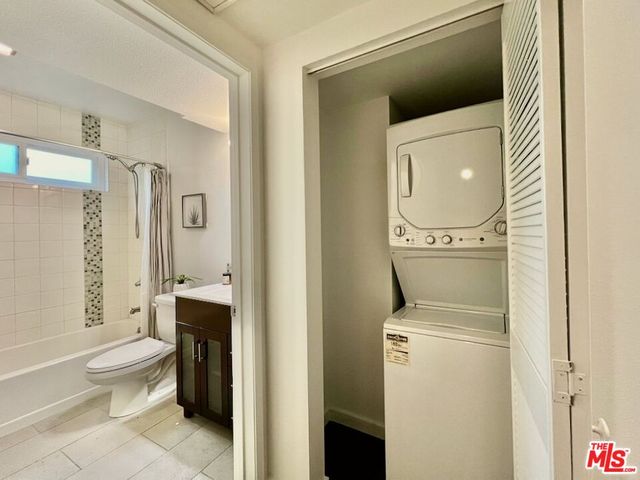a bathroom with a toilet a sink and shower