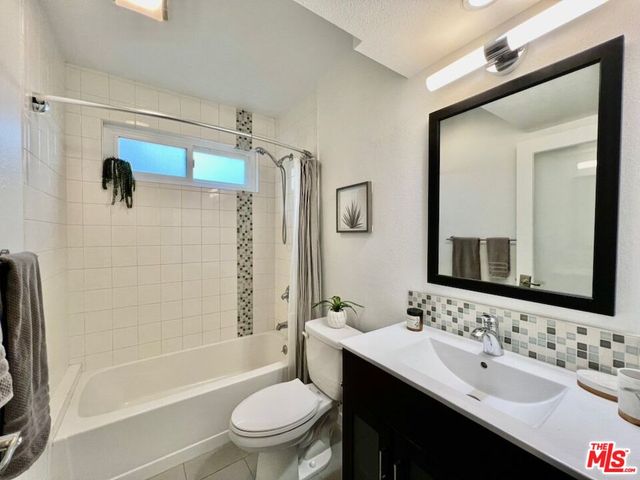a bathroom with a sink toilet tub and shower