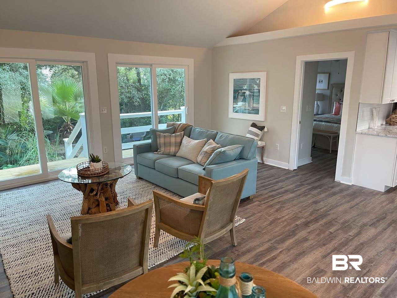 413 West Fort Morgan Road Gulf Shores, AL 36542 - Photo 10 of 29 Living room featuring dark wood-type flooring, lofted ceiling, and baseboards