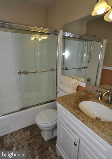 11206 Lagoon Lane Reston, VA 20191 - Photo 11 of 27 a bathroom with a granite countertop sink toilet and shower