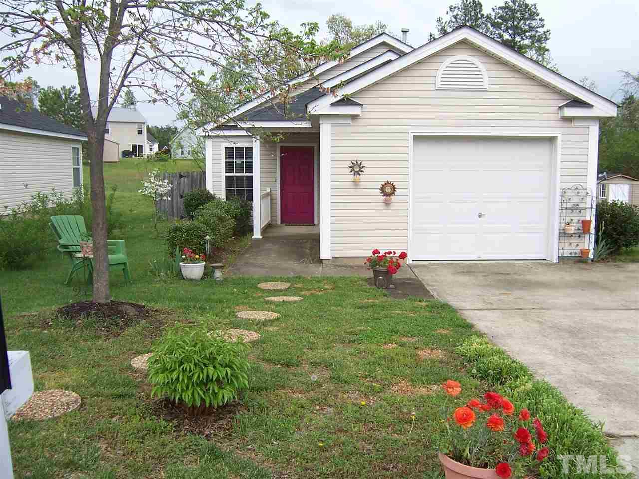 4948 Silverdene Street Raleigh, NC 27616 - Photo 3 of 20 a front view of a house with a yard and garage