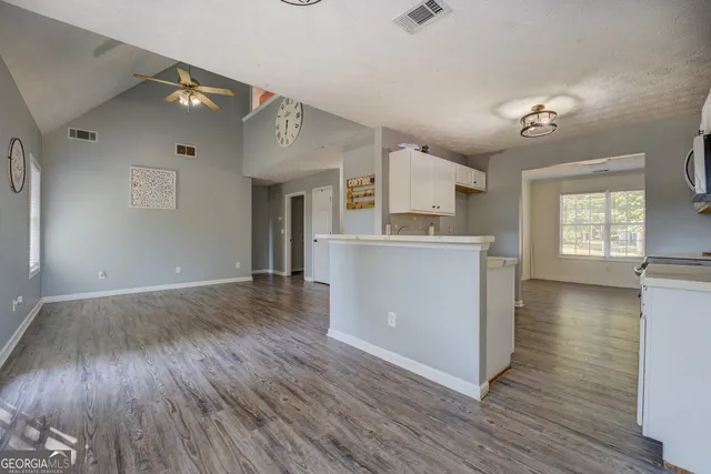 wooden floor in an empty room with a window and wooden floor