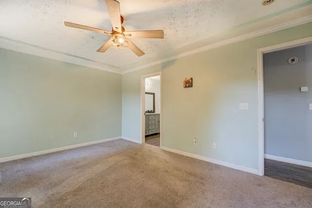 a view of an empty room with a ceiling fan