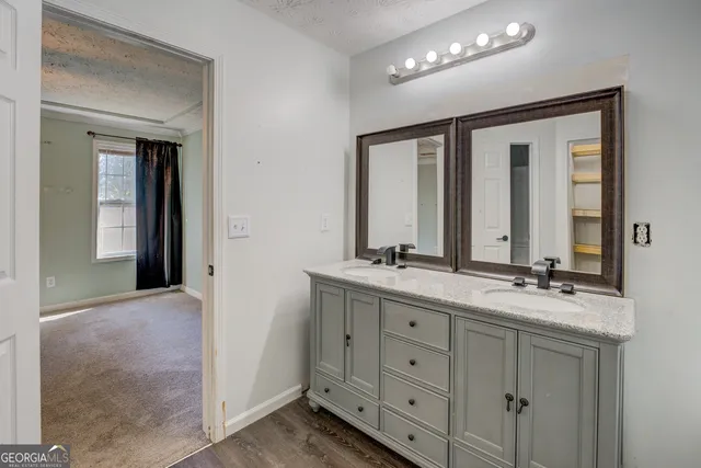 a bathroom with double sink and a mirror