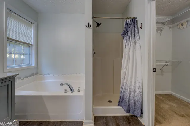 a bathroom with a bathtub and a shower