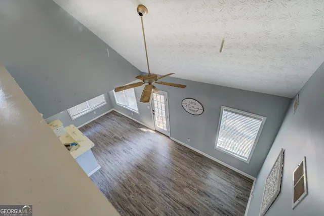 a view of a hallway with wooden floor