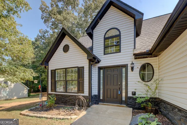 a front view of a house with garden