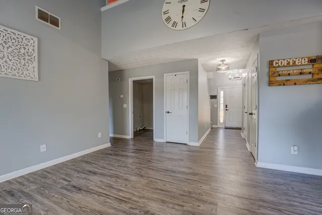 a view of a hallway with wooden floor