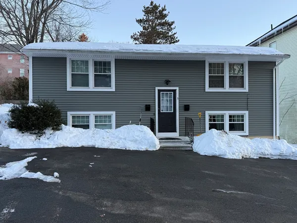 a view of a house with a yard and garage