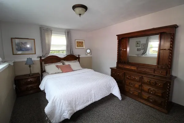 a bedroom with a bed and a television