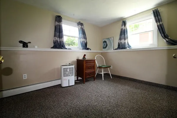 a room with a window and a fireplace