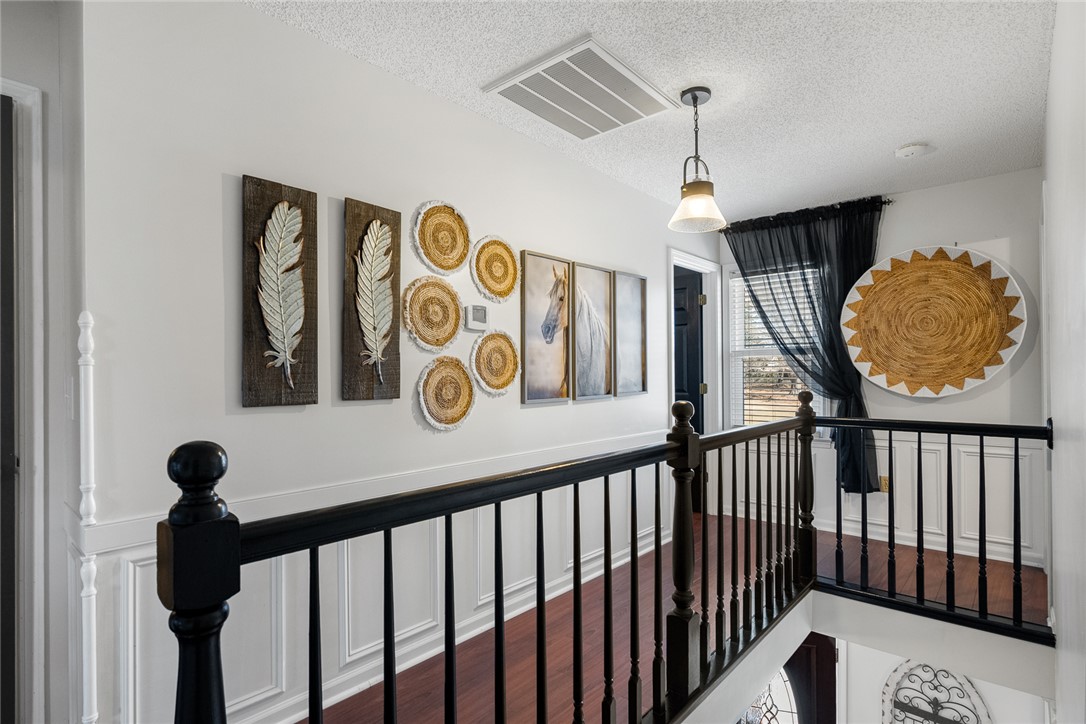 112 C-10-220 Anderson, SC 29621 - Photo 24 of 45 This spacious hallway features rich hardwood flooring and classic wainscoting.