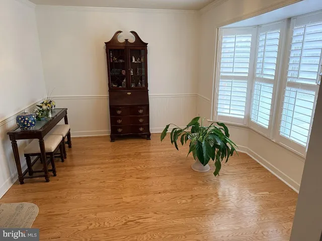 a view of a entryway with furniture and wooden floor