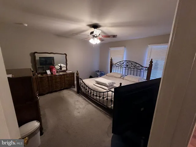 a bedroom with a bed and a television